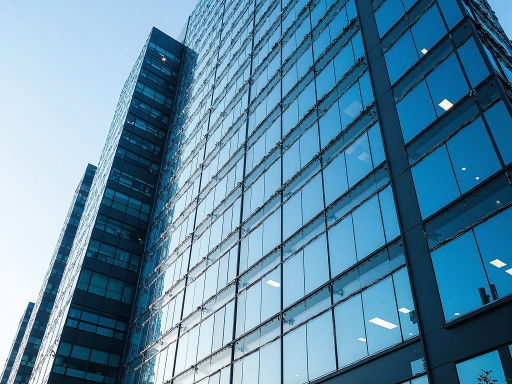 Modern office building exterior with glass facade design, bright sunlight, reflecting international corporate image